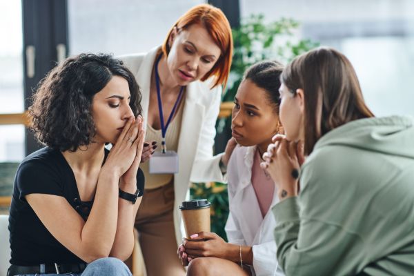 Mental health professional supporting individuals discussing anxiety and coping strategies.