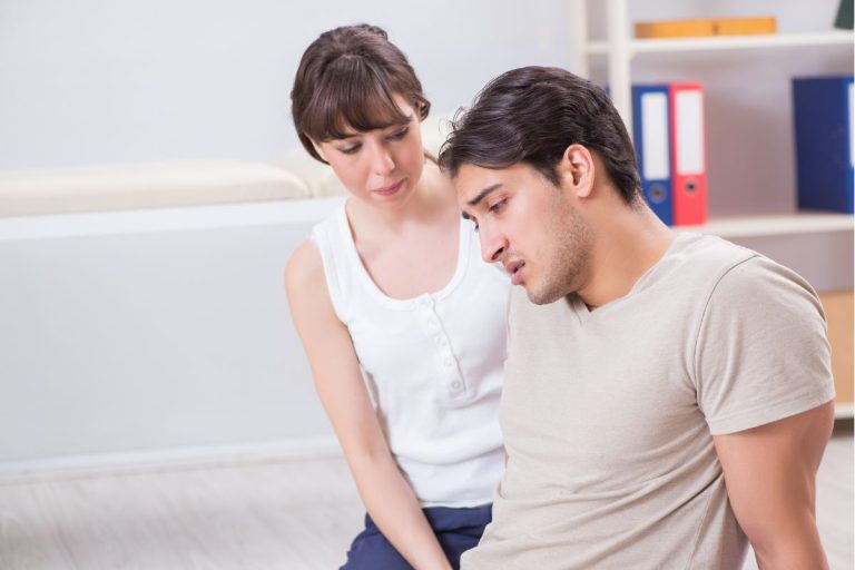 Couple receiving trauma-focused therapy and support in a clinical setting.