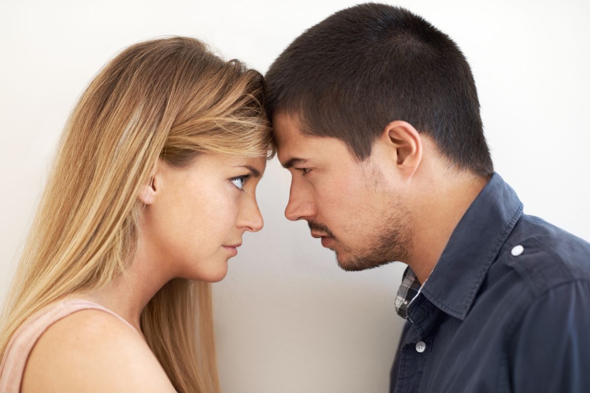 Couple facing each other illustrating emotional tension and protecting mental health.