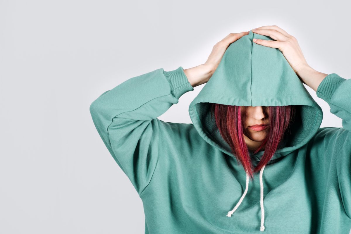 Person in hoodie illustrating emotional highs and lows of Borderline Personality Disorder and Bipolar Disorder.