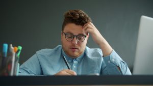 Man experiencing social anxiety, considering psychiatric services and treatment options.